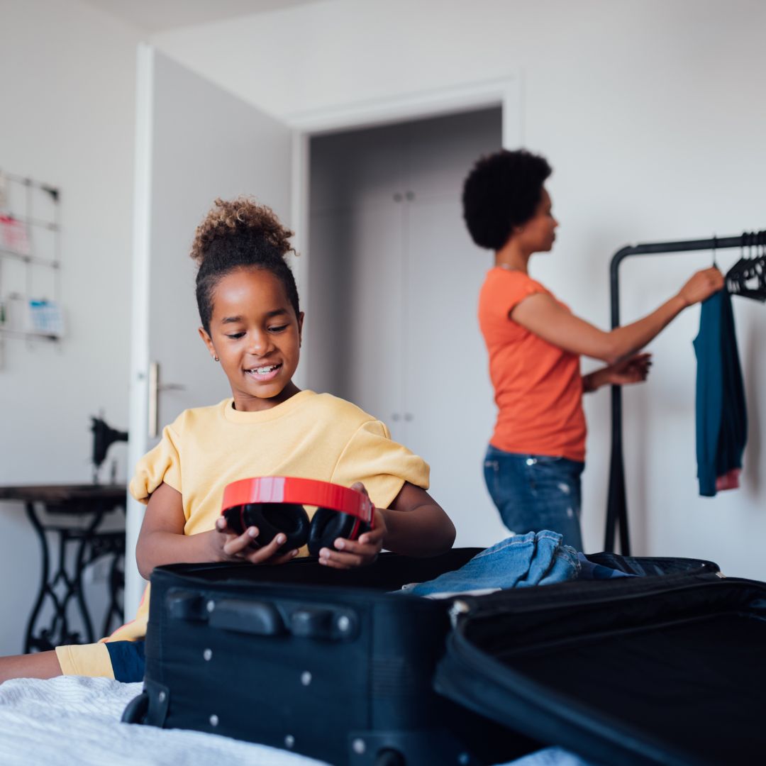 Mother and a daughter packing their luggage case