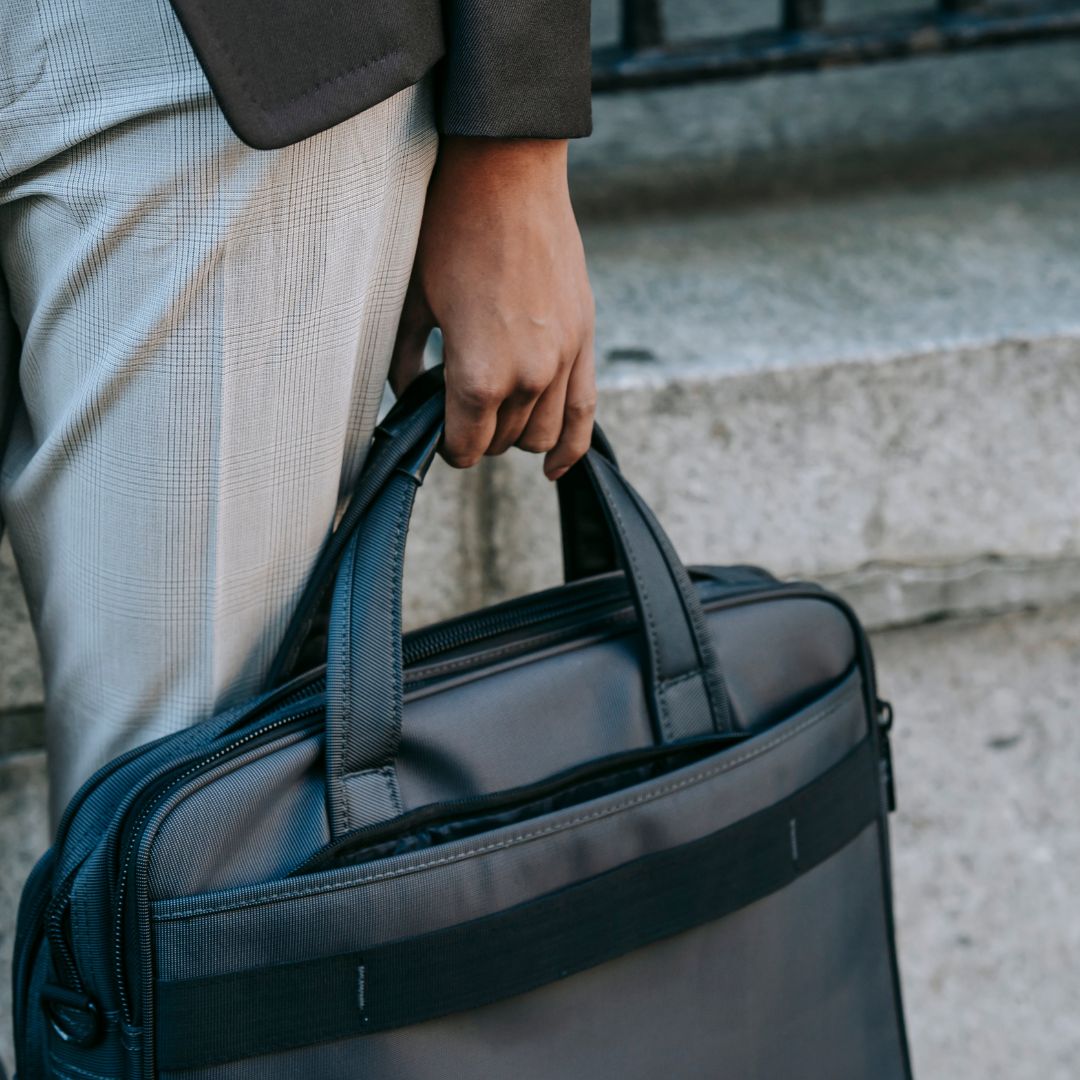 entrepreneur with laptop in bag